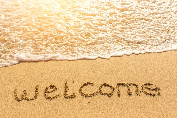 Willkommen - gezeichnet auf Sand am Strand — Stockfoto