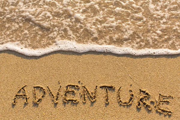 Adventure - drawn  on the beach sand — Stock Photo, Image