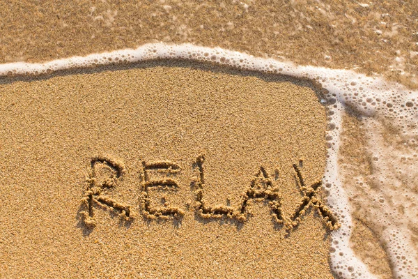 Relaxe - desenhado na areia — Fotografia de Stock