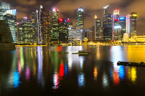 SINGAPORE - CIRCA FEB, 2016: Buildings skyline in business district Marina Bay at night time. Singapore is considered a global financial hub.