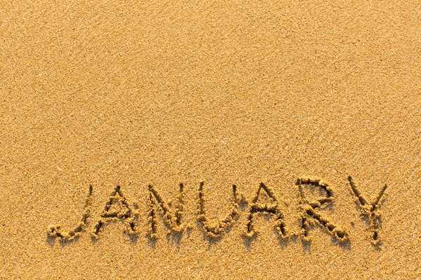 Januari word på sand — Stockfoto