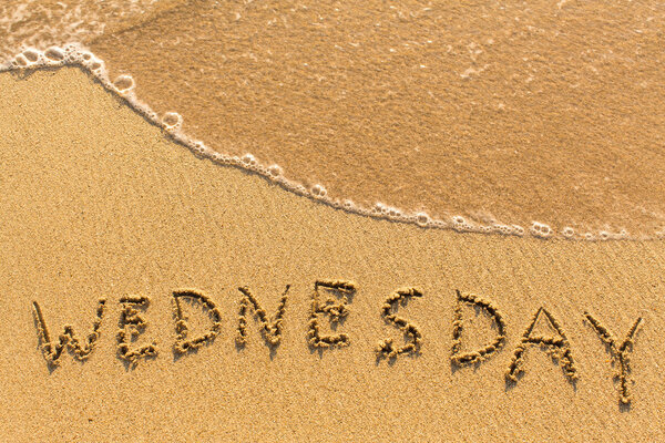 Wednesday  inscription on sand