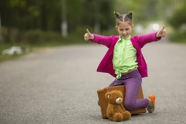 Little girl sitting on the road — Stock Photo, Image