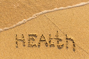 Health - word drawn on the sand