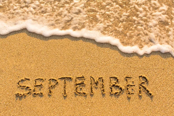 September -  written on sandy beach — Zdjęcie stockowe