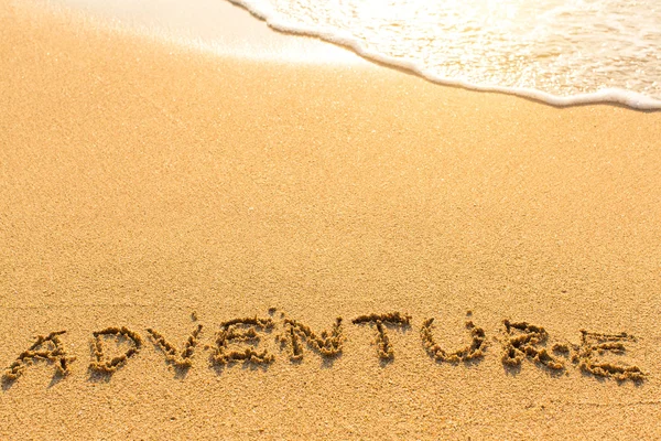 Adventure word drawn on sand — Stock Photo, Image