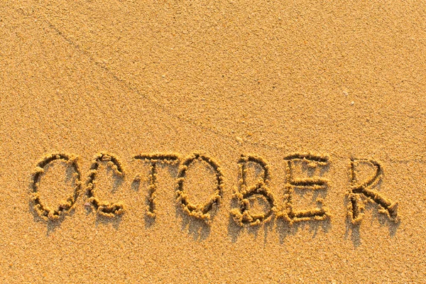 Październik - rysowane ręcznie na piaszczystej morze — Zdjęcie stockowe