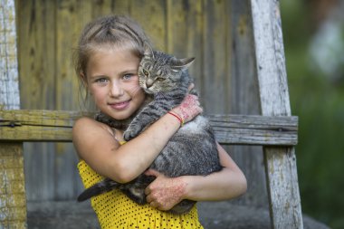 Küçük kız kediyle oynuyor..
