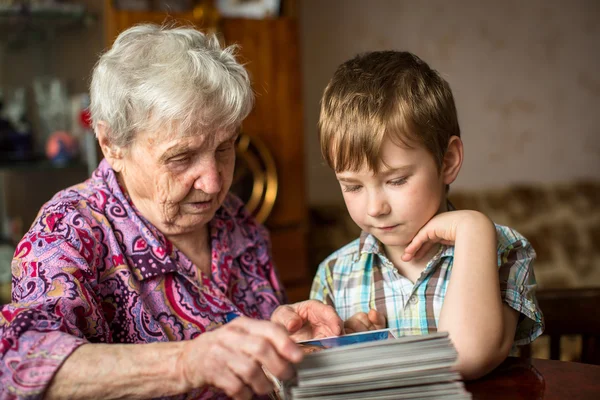 Oma zeigt Enkel Fotoalbum. — Stockfoto