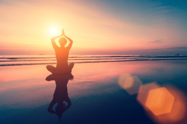 Meditasyon kız gün batımında silüeti