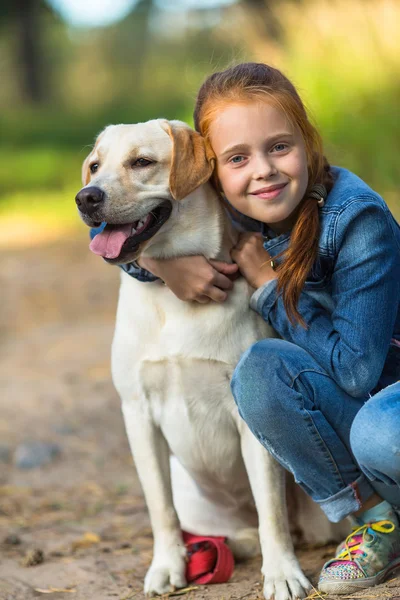 Küçük kız kucaklayan köpek — Stok fotoğraf