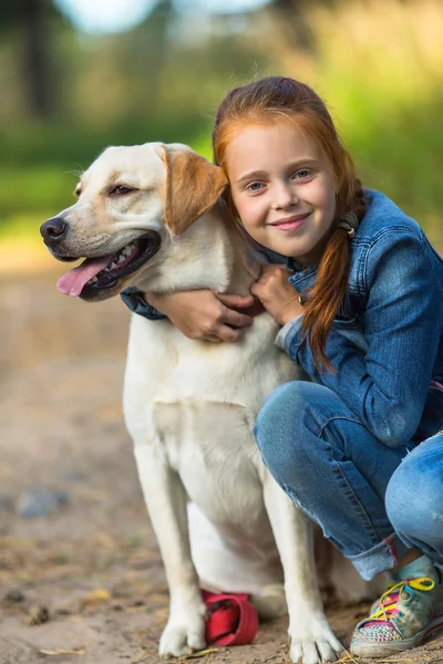 Little girl hugging dog — Stock Photo, Image