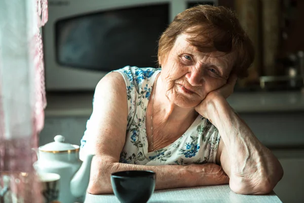 Uma Idosa Aposentada Senta Uma Mesa Sua Casa Retrato — Fotografia de Stock