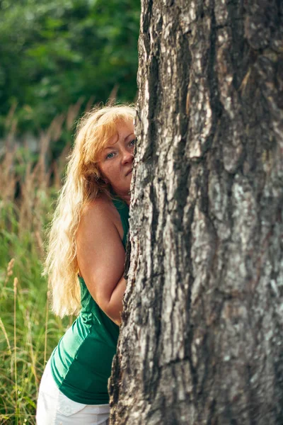 Μια Γυναίκα Όμορφα Χρυσά Μαλλιά Στο Πάρκο Κοντά Ένα Πεύκο — Φωτογραφία Αρχείου
