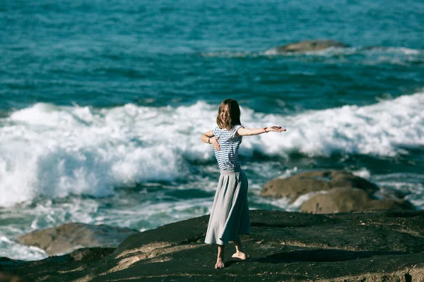 若い女性が海沿いで自由に踊る — ストック写真