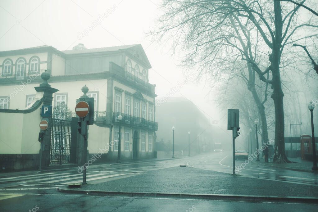 View of the buildings on foggy street, Porto, Portugal.