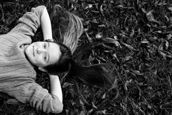 Teen Girl Laying Autumn Ground Long Hair Scattered Grass Black — Stock Photo, Image