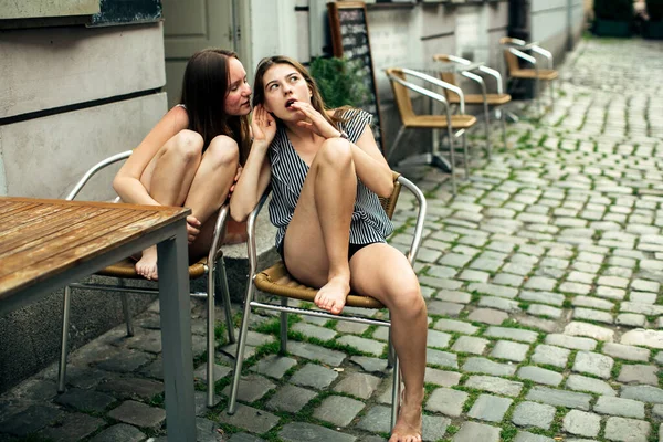 Two Girl Friends Sitting Table Outdoors Cafe Whispering — Stock Photo, Image