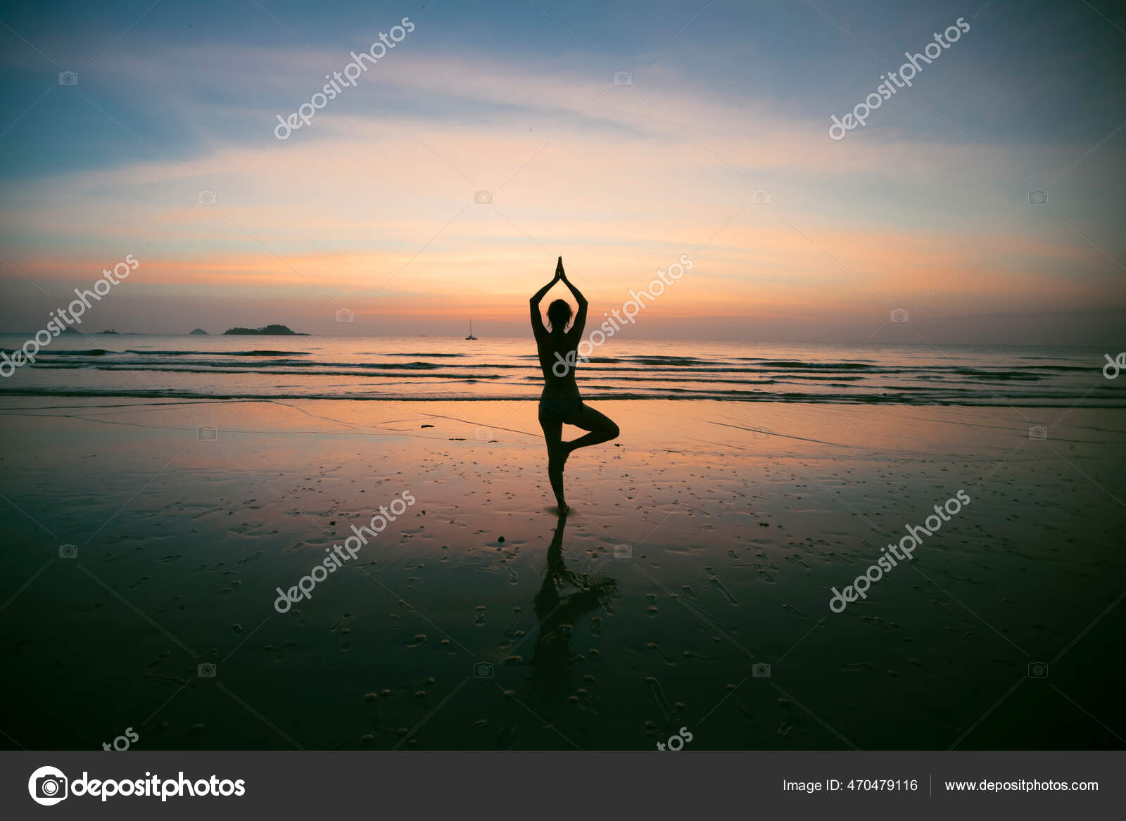 Silhouette Of Woman Standing At Yoga Pose On The Beach During An