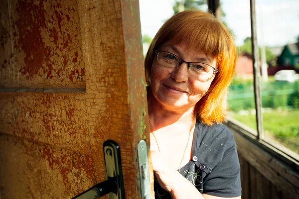 Middle Aged Woman Looks Out Door House Village — Stock Photo, Image