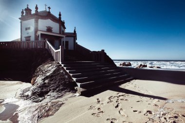 View of Chapel Senhor da Pedra on Praia de Miramar, Vila Nova de Gaia, Portugal. clipart