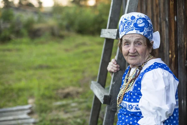 Old woman in russian ethnic clothes — Stock Photo, Image
