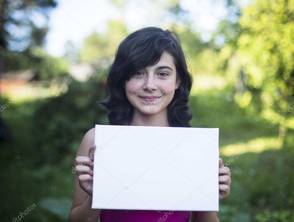 Girl holding white paper