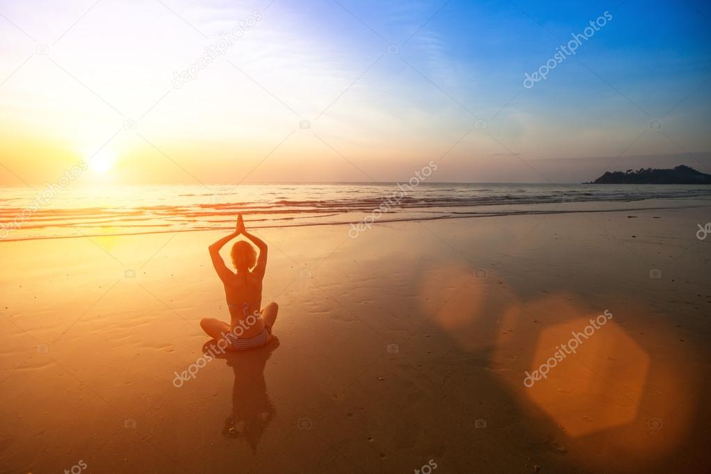 Yoga woman on sea beach