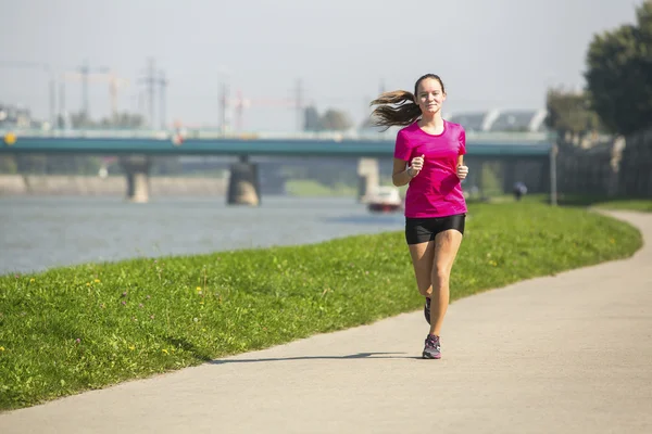 Young cute jogger girl runs — Stock Photo, Image