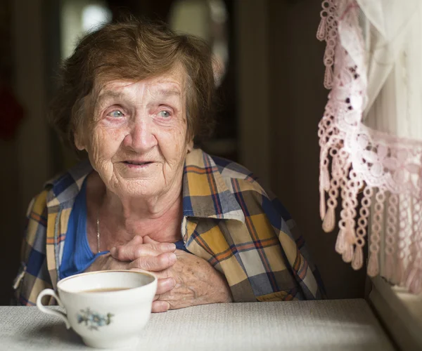 Old woman with tea — Stock Photo, Image