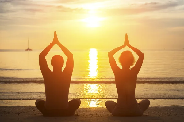 Pareja practicando yoga — Foto de Stock