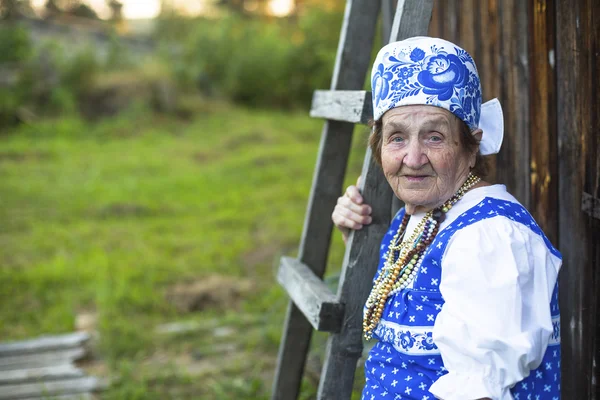 Old woman in village — Stock Photo, Image