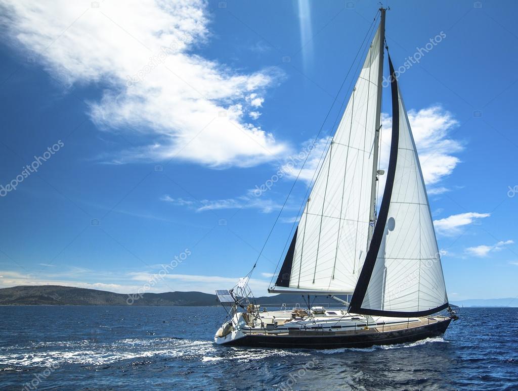 Sailing yachts with white sails