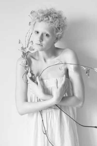 Girl with a dry tree branch — Stock Photo, Image