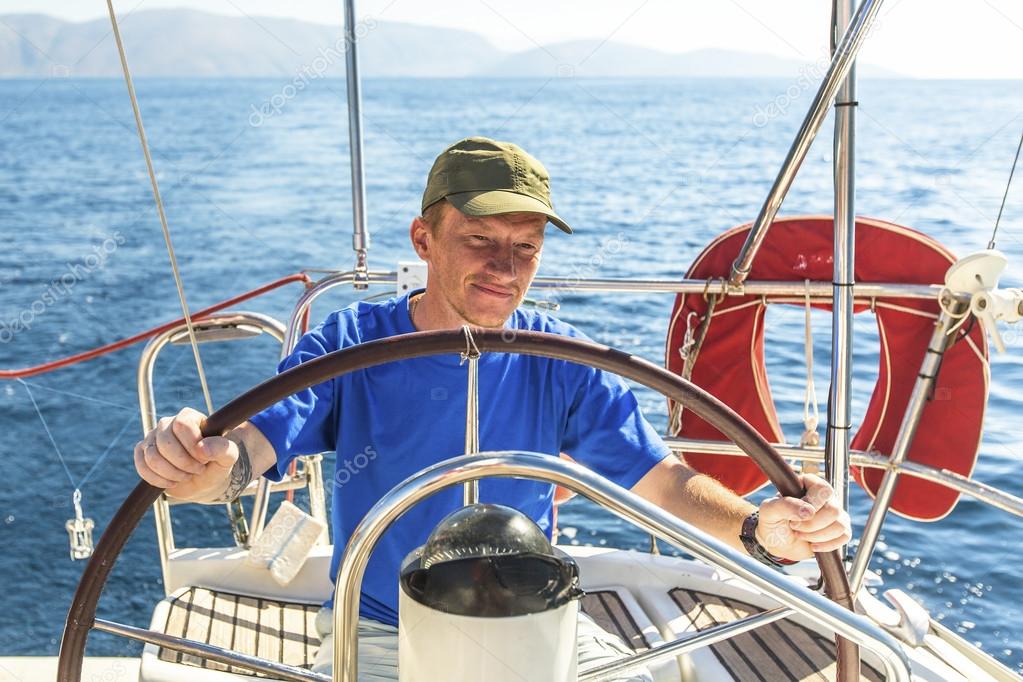 Young man skipper on  yacht.