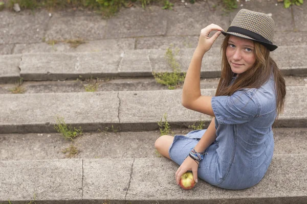 Young girl sitting on  steps — Stock Photo, Image