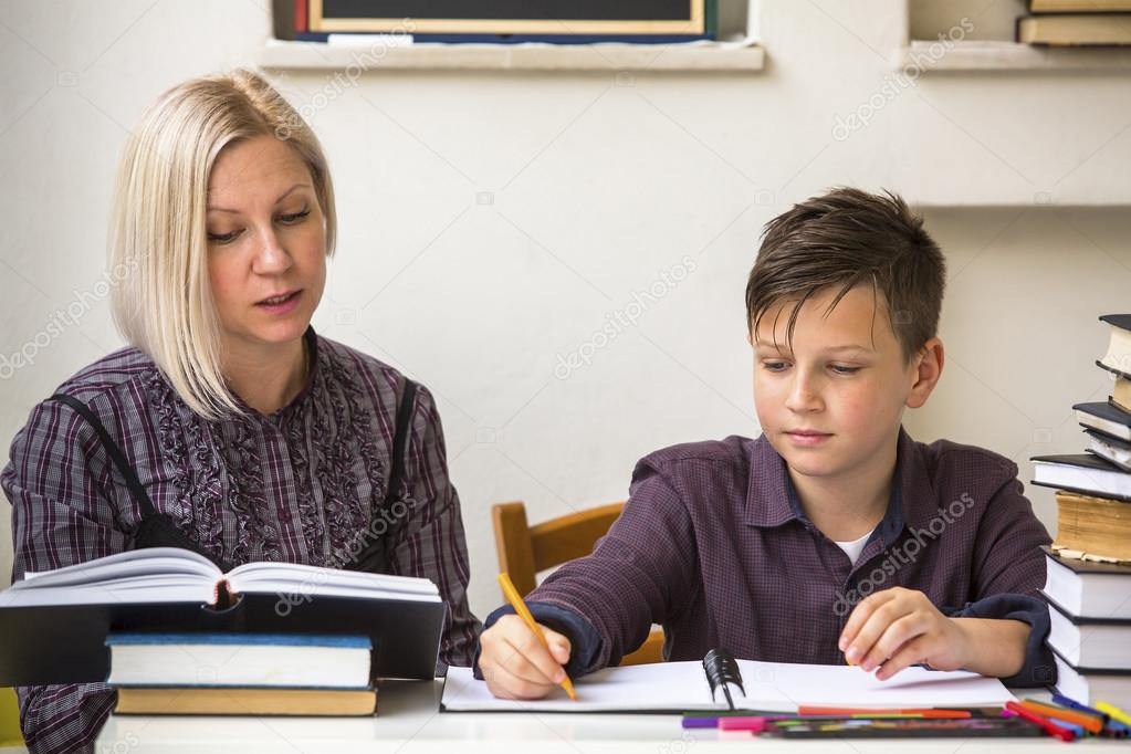 Student does homework with his tutor