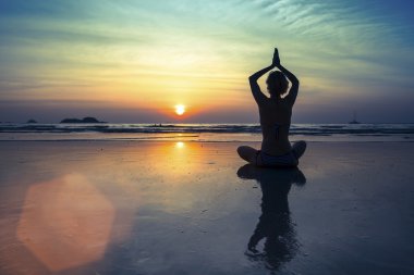Female silhouette in Yoga meditation pose clipart