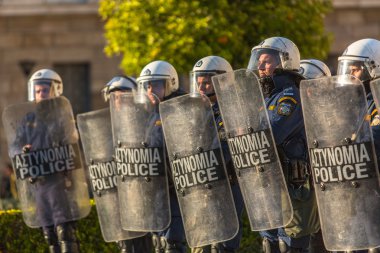 Riot police with their shields clipart