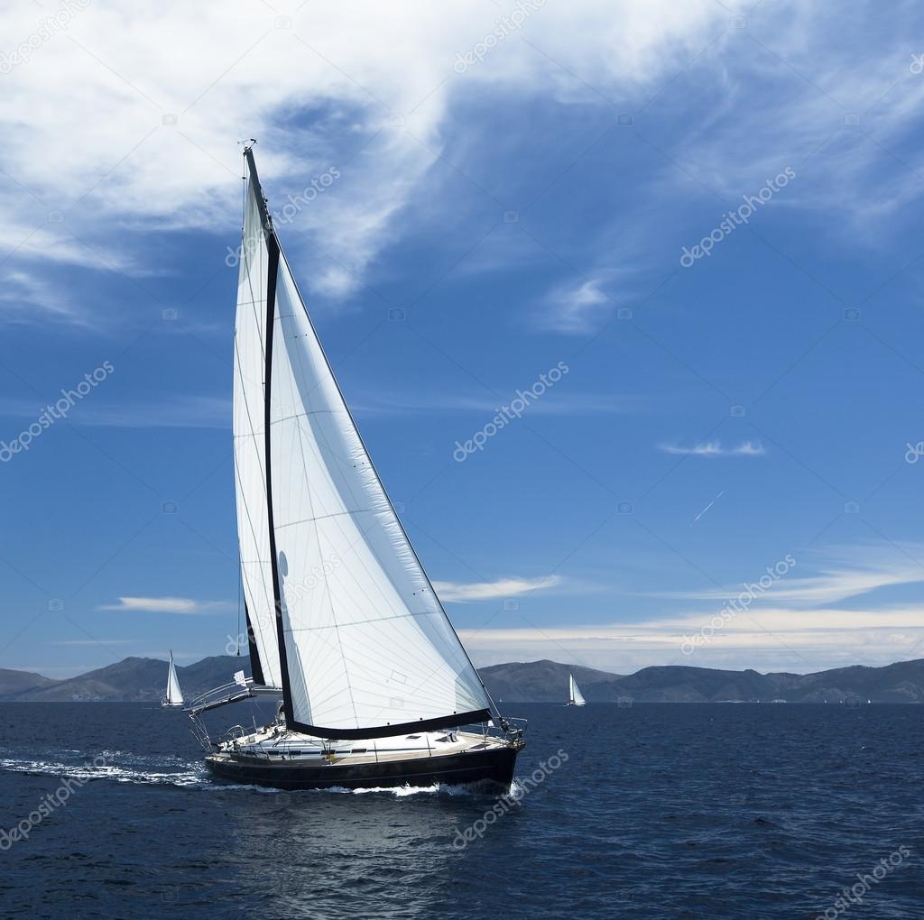Yacht sails with beautiful cloudless sky