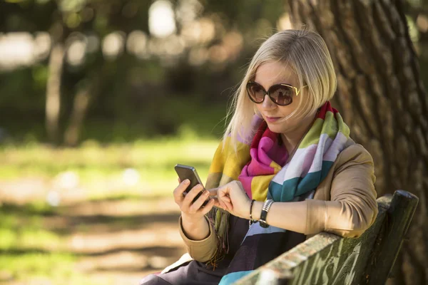 Young woman with smartphone in hands — Stock Photo, Image