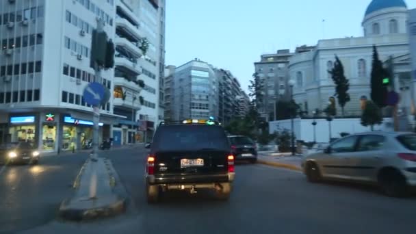 Driving on the streets at Athens, twilight, the road to the Port, view through the front windshield. — Stock Video