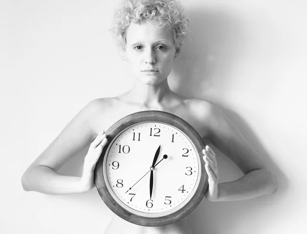 Sensitive curly girl with big clock — Stock Photo, Image