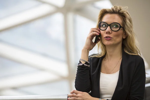 Mujer con gafas hablando por teléfono móvil — Foto de Stock