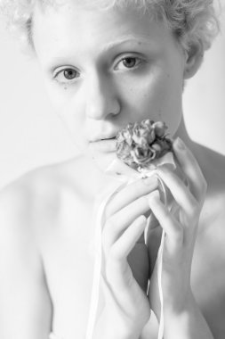 Young gentle woman keeps dry flower