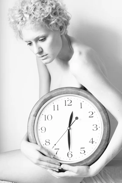 Young gentle woman with big clock — Zdjęcie stockowe