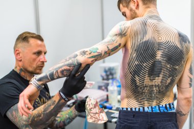 People make tattoos at Tattoo Convention