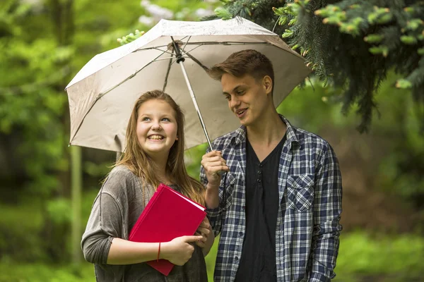 Girl with red book and guy — Stok fotoğraf