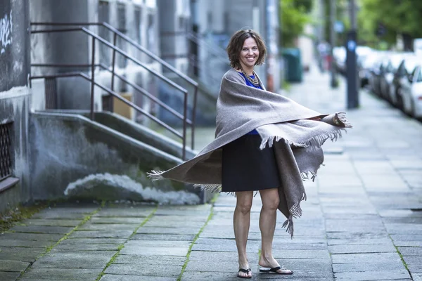 Beautiful woman in poncho — Stock Photo, Image