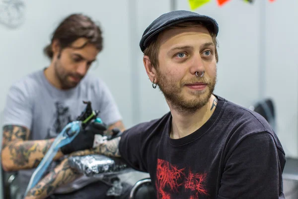 People make tattoos at Tattoo Convention — Stok fotoğraf